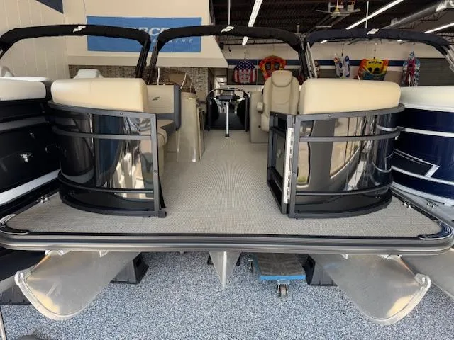 Slide: The Image of 2025 Starcraft EXS 1 pontoon boat interior with beige seating and sleek black railings. - 2
