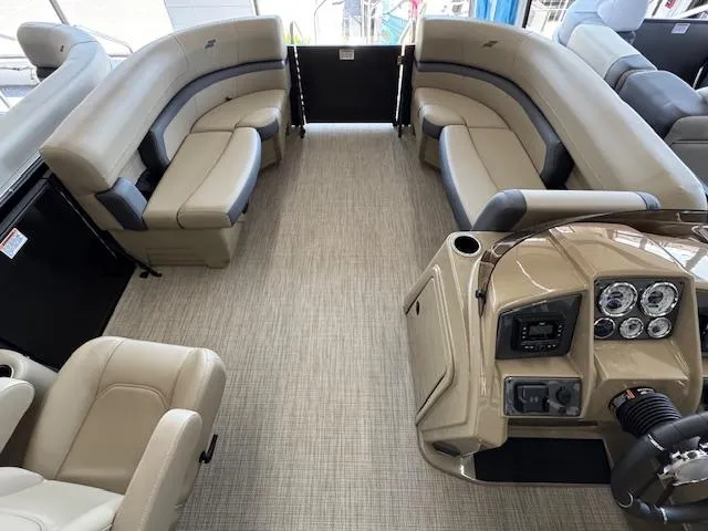 Slide: The Image of 2025 Starcraft EXS 1 boat interior with beige seating and modern dashboard. - 4