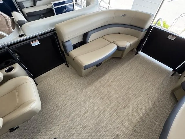 Slide: The Image of Interior of 2025 Starcraft EXS 1 boat with beige seating and carpeted floor. - 7