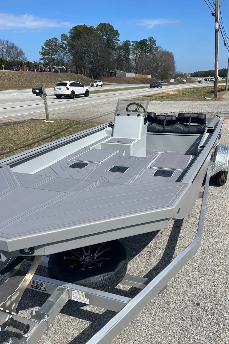 Slide: The Image of 2024 Thor 1860 Lake Hammer Side Console boat on trailer, parked roadside. - 3