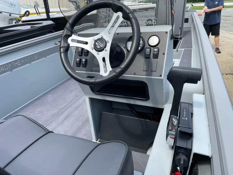 Slide: The Image of 2024 Thor 1860 Lake Hammer Side Console boat interior with steering wheel and controls. - 5