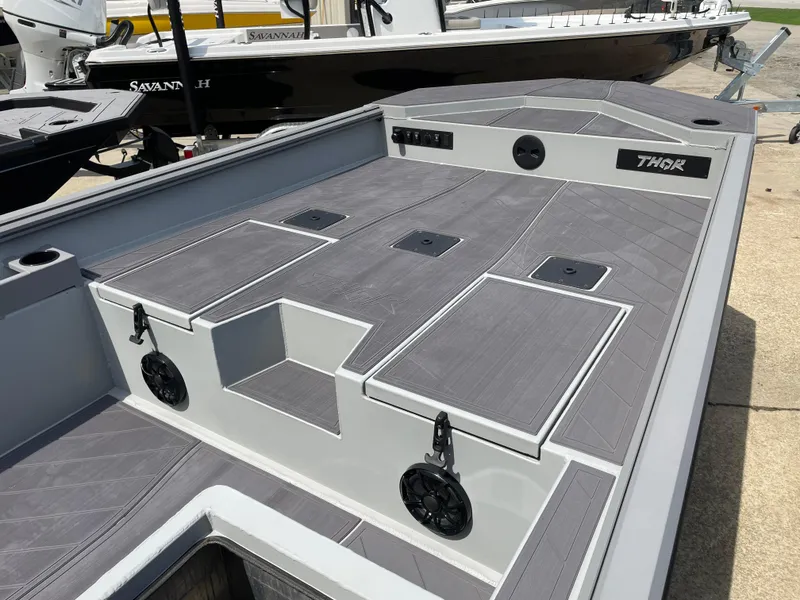 Slide: The Image of 2024 Thor 1860 Lake Hammer Side Console boat with sleek gray deck design. - 6