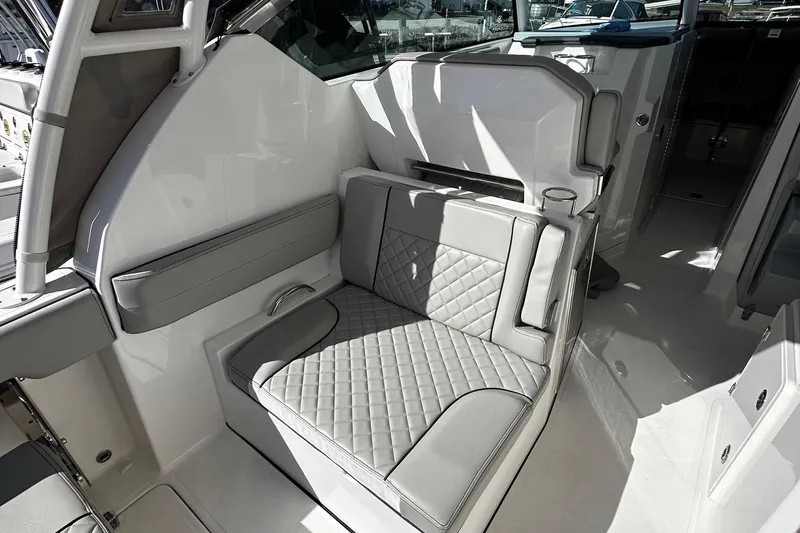 Slide: The Image of 2022 Pursuit DC 295 Dual Console interior with quilted seating and modern design. - 10
