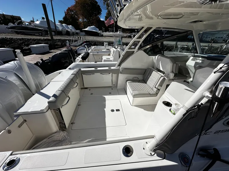 Slide: The Image of 2022 Pursuit DC 295 Dual Console boat interior with seating and storage. - 2