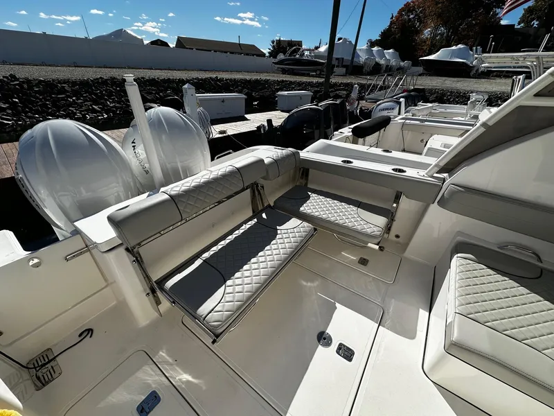 Slide: The Image of 2022 Pursuit DC 295 Dual Console boat interior with cushioned seating and modern design. - 3