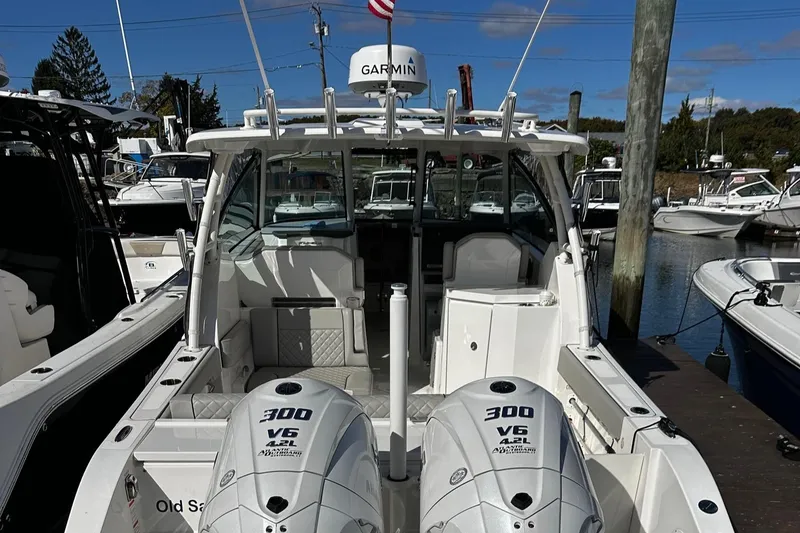 Slide: The Image of 2022 Pursuit DC 295 Dual Console boat with twin 300 V6 engines docked at marina. - 9
