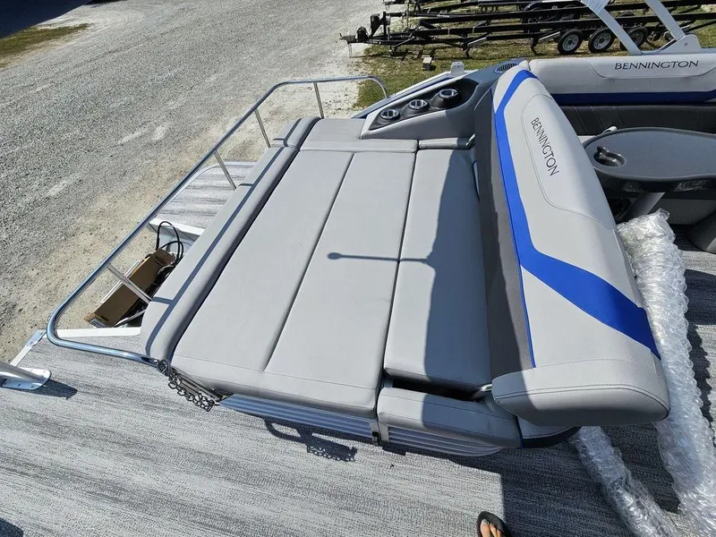 Slide: The Image of 2025 Bennington 22 SXSB boat with gray and blue seating on a sunny day. - 3