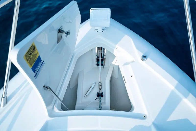 Slide: The Image of Tiara Yachts 2025 48 LE anchor locker, open on calm blue water. - 11