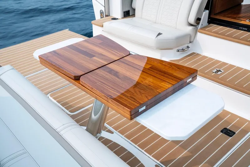 Slide: The Image of Luxury teak table on 2025 Tiara Yachts 48 LE deck. - 16
