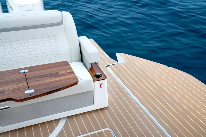 Slide: The Image of Luxurious seating on 2025 Tiara Yachts 48 LE, featuring elegant wood accents and ocean backdrop. - 20