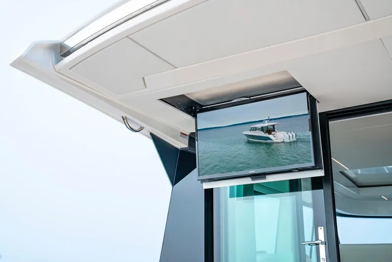 Slide: The Image of Tiara Yachts 48 LE 2025 model with outdoor TV display on deck. - 23
