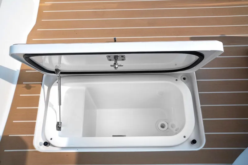 Slide: The Image of Open storage compartment on 2025 Tiara Yachts 48 LE deck. - 26