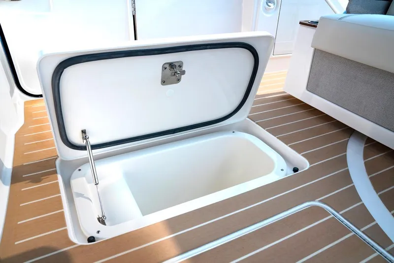 Slide: The Image of Open storage compartment on 2025 Tiara Yachts 48 LE deck. - 27