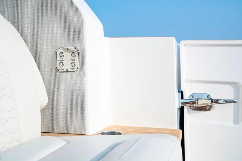 Slide: The Image of Interior detail of 2025 Tiara Yachts 48 LE, featuring sleek white seating and control panel. - 30