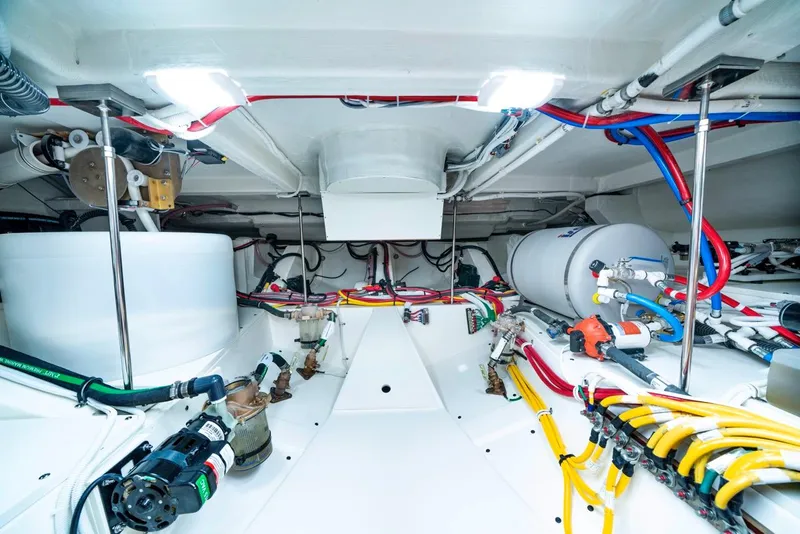 Slide: The Image of Engine room of 2025 Tiara Yachts 48 LE, showcasing advanced wiring and equipment. - 34