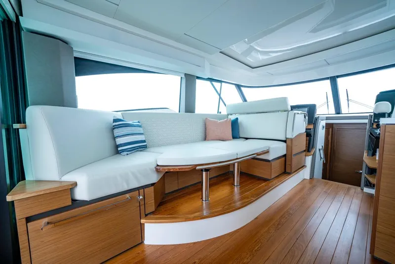 Slide: The Image of Luxurious interior of 2025 Tiara Yachts 48 LE with elegant seating and wooden flooring. - 36