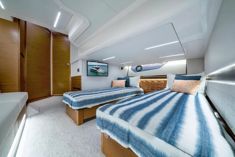 Slide: The Image of Luxurious 2025 Tiara Yachts 48 LE cabin with twin beds and modern decor. - 47