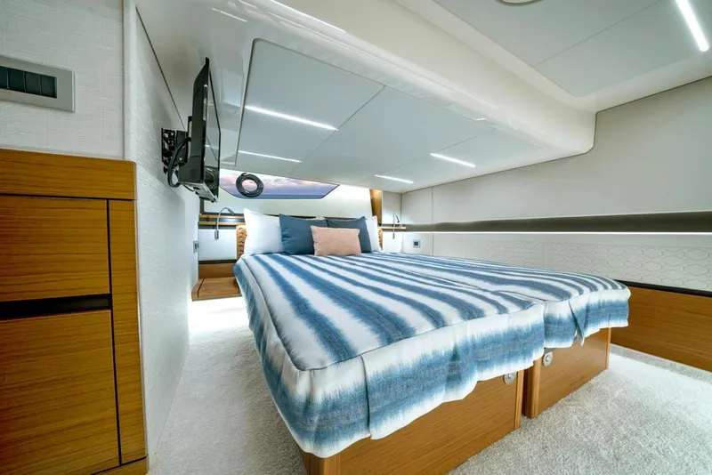 Slide: The Image of Luxurious 2025 Tiara Yachts 48 LE cabin with modern design and comfortable bedding. - 49
