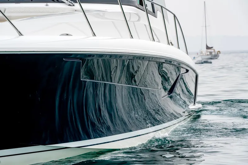 Slide: The Image of 2025 Tiara Yachts 48 LE cruising on calm waters. - 6