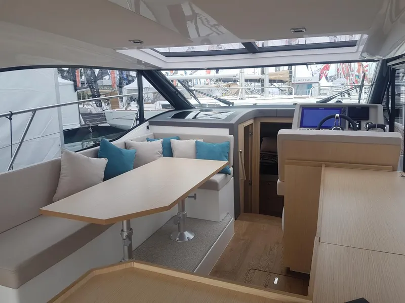 Slide: The Image of Interior of 2025 Skamander Monaco Coupe yacht with modern seating and navigation area. - 10