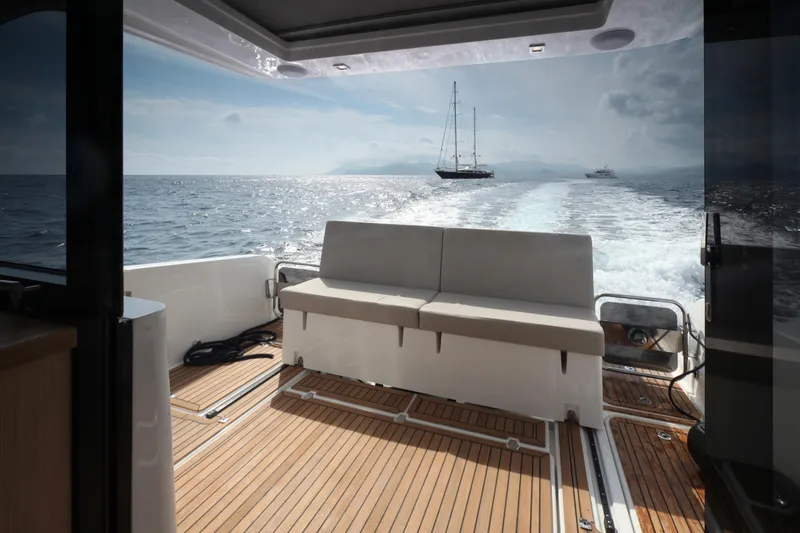 Slide: The Image of 2025 Skamander Monaco Coupe boat interior with ocean view and distant sailboat. - 25