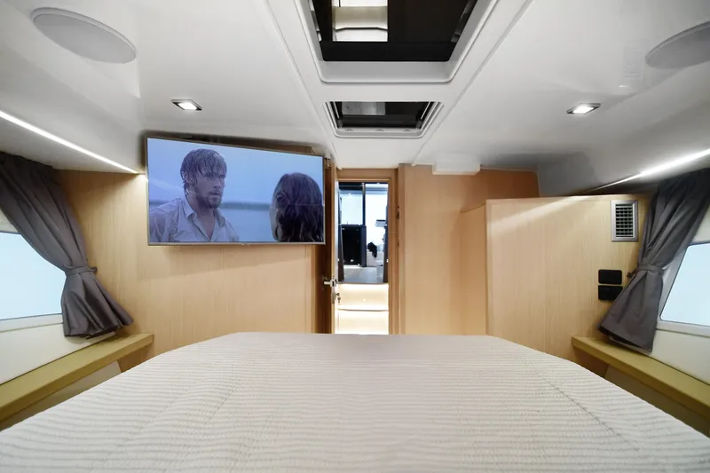 Slide: The Image of Interior of 2025 Skamander Monaco Coupe with TV, bed, and modern design. - 31