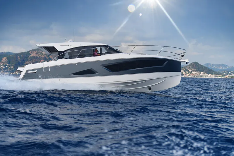 Slide: The Image of 2025 Skamander Monaco Coupe yacht cruising on open sea under sunny sky. - 36