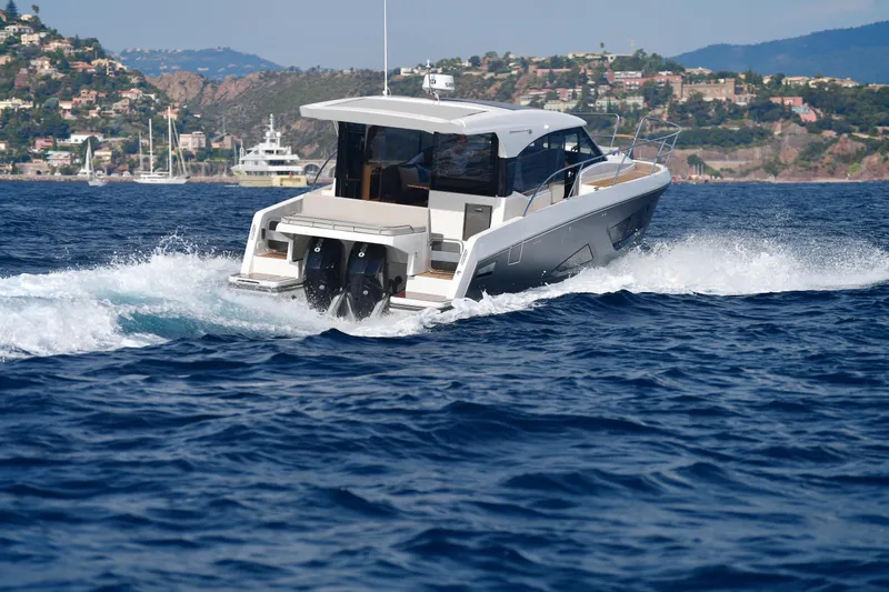 Slide: The Image of 2025 Skamander Monaco Coupe cruising on blue ocean waters near scenic coastline. - 37