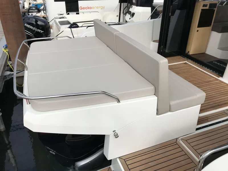 Slide: The Image of 2025 Skamander Monaco Coupe boat with cushioned seating and wooden deck. - 6