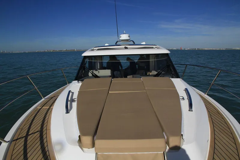 Slide: The Image of 2025 Skamander Monaco Coupe yacht on open water, featuring sleek design and spacious deck. - 7