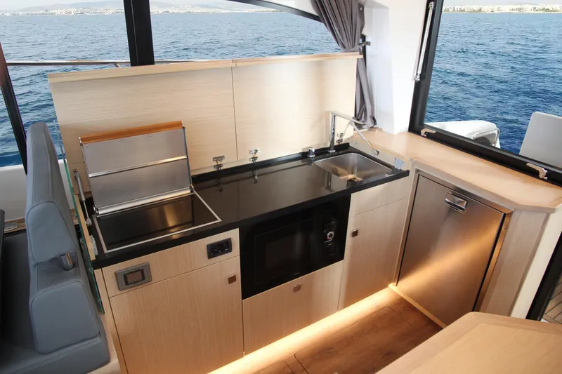 Slide: The Image of Modern kitchen interior in 2025 Skamander Monaco Coupe yacht, featuring sleek appliances and ocean view. - 8