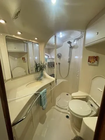 Slide: The Image of Luxurious bathroom in 2003 Sea Ray 480 Sedan Bridge yacht, featuring modern fixtures and elegant design. - 12