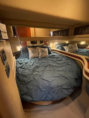 Slide: The Image of Cozy bedroom in 2003 Sea Ray 480 Sedan Bridge yacht with blue bedding. - 17