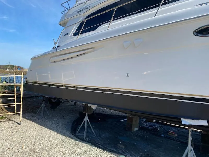 Slide: The Image of 2003 Sea Ray 480 Sedan Bridge yacht on dry dock, side view. - 5