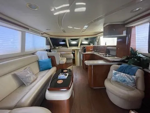 Slide: The Image of Luxurious interior of 2003 Sea Ray 480 Sedan Bridge yacht with elegant seating and modern kitchen. - 9
