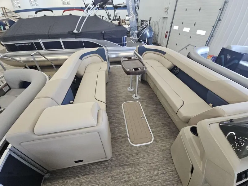 Slide: The Image of 2025 Godfrey Sweetwater 2486 SFL GTP pontoon boat interior with beige seating and table. - 11