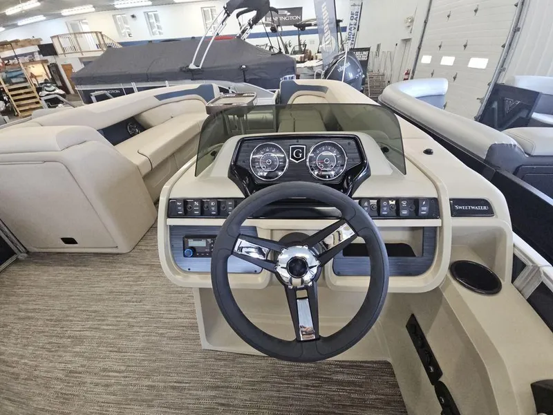 Slide: The Image of 2025 Godfrey Sweetwater 2486 SFL boat dashboard with steering wheel and control panel. - 8