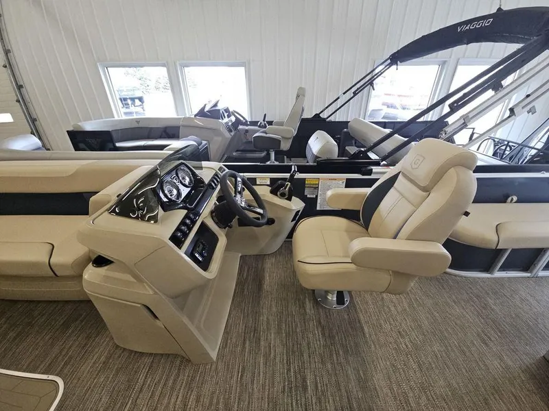 Slide: The Image of 2025 Godfrey Sweetwater 2486 SFL boat interior with beige seating and modern dashboard. - 9
