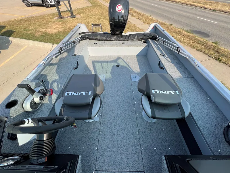 Slide: The Image of 2025 Lund 1875 Alaskan Sport boat interior with dual seats and steering console. - 10