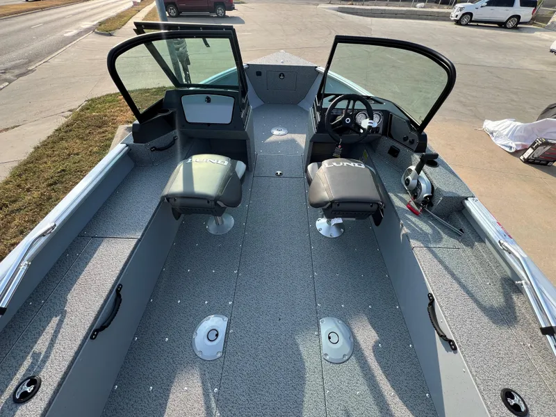 Slide: The Image of 2025 Lund 1875 Alaskan Sport boat interior with open windshield and seating. - 5
