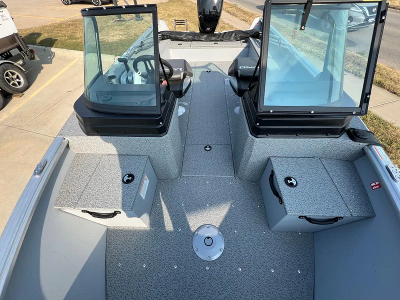 Slide: The Image of 2025 Lund 1875 Alaskan Sport boat interior with dual consoles and storage compartments. - 8