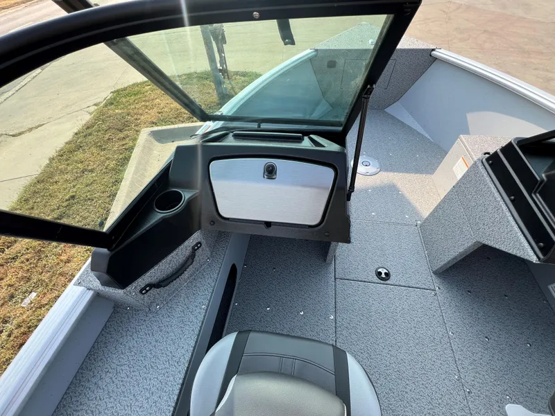 Slide: The Image of 2025 Lund 1875 Alaskan Sport boat interior with open windshield and seating. - 9