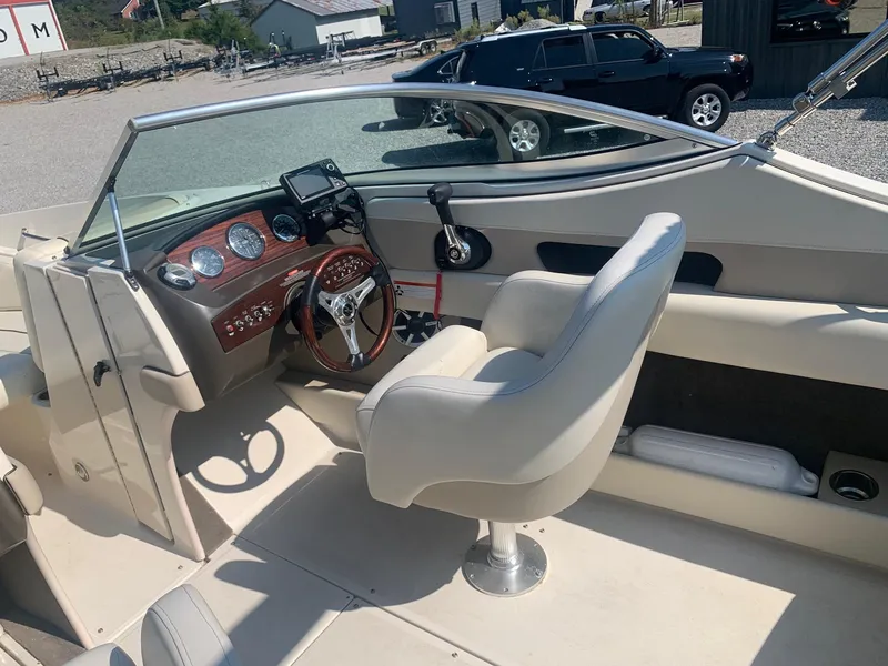 Slide: The Image of 2009 Sea Ray 230 Sundeck boat interior with steering wheel and dashboard. - 10
