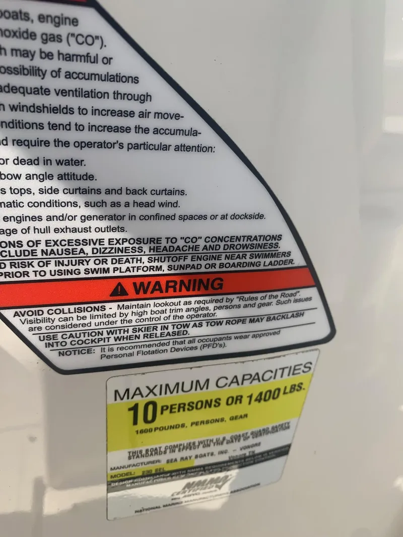 Slide: The Image of Warning label on 2009 Sea Ray 230 Sundeck, maximum capacity 10 persons or 1400 lbs. - 18