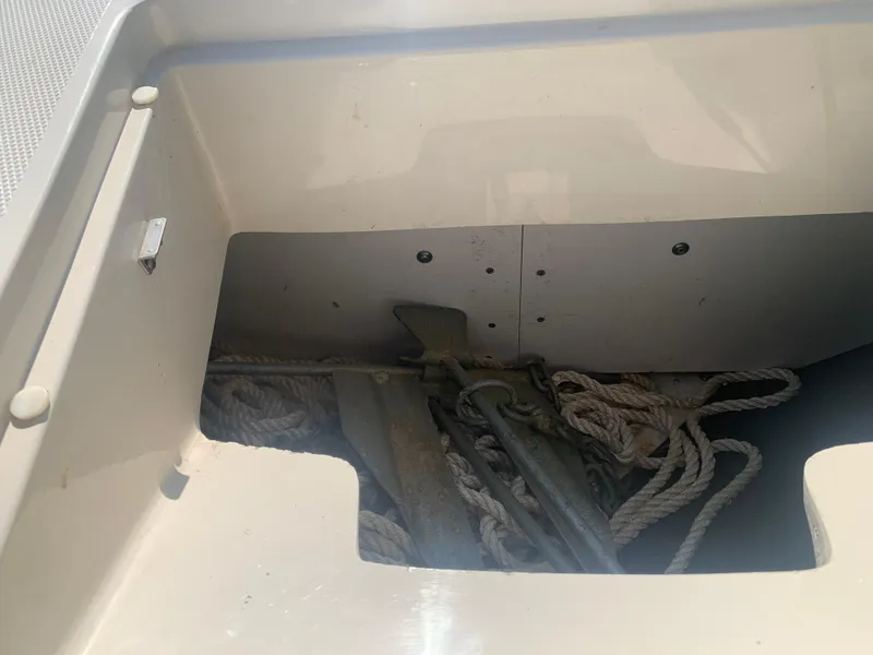 Slide: The Image of 2009 Sea Ray 230 Sundeck anchor storage with ropes and anchor visible. - 19