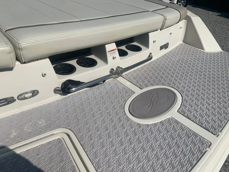 Slide: The Image of 2009 Sea Ray 230 Sundeck boat deck with seating and textured flooring. - 22