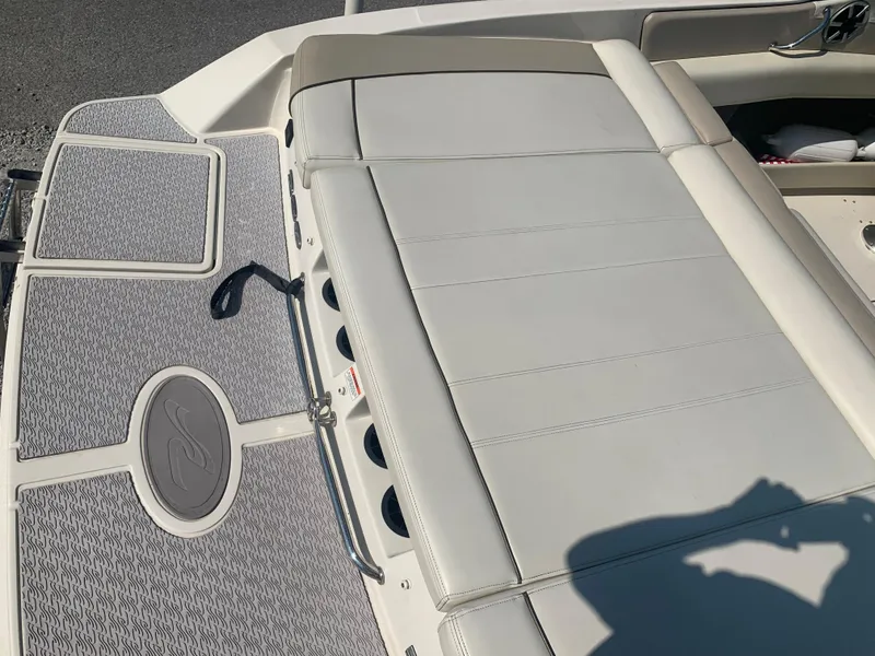 Slide: The Image of 2009 Sea Ray 230 Sundeck boat with cushioned seating and deck details. - 24