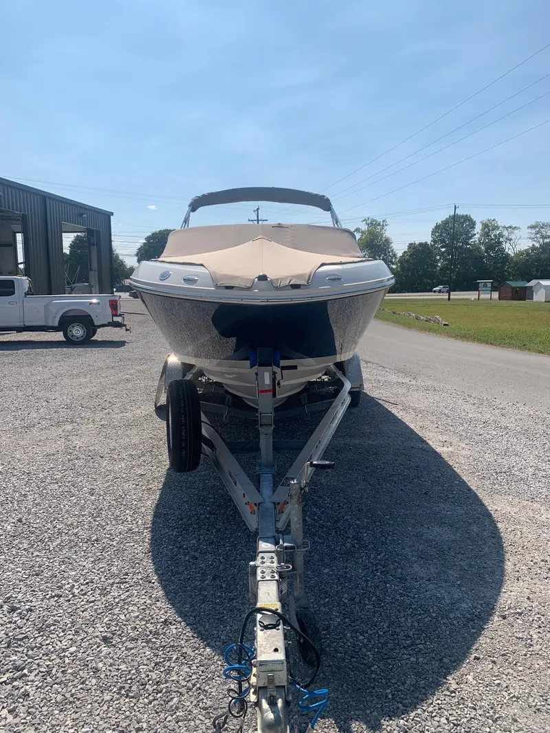 Slide: The Image of 2009 Sea Ray 230 Sundeck boat on trailer in outdoor setting. - 3