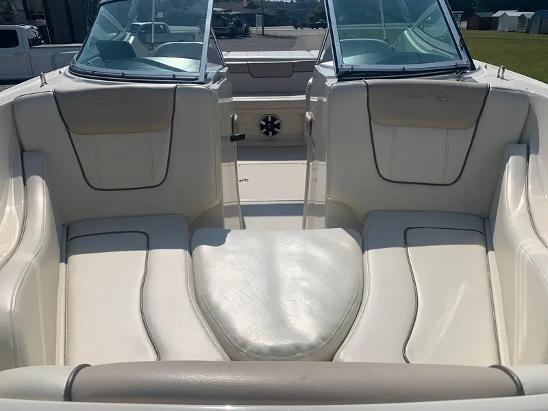 Slide: The Image of 2009 Sea Ray 230 Sundeck interior with cream leather seating and dual windshields. - 6