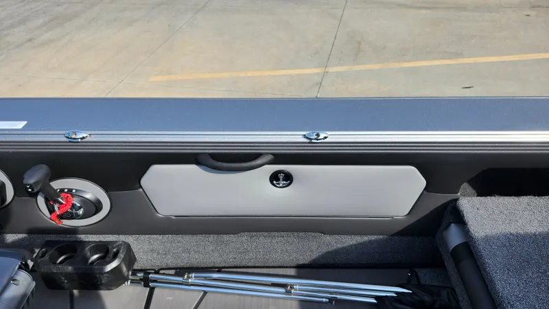 Slide: The Image of 2025 Lund 1875 Tyee boat interior with storage compartment and control panel. - 10